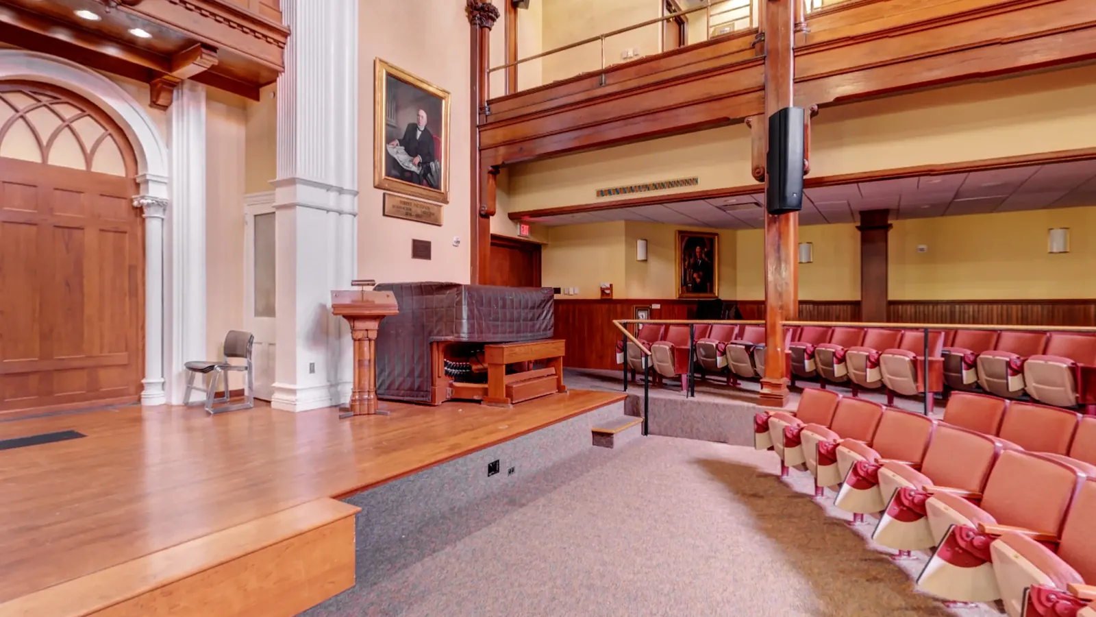 The 464-seat auditorium from the floor, beneath the timber trusses and the Heefner organ