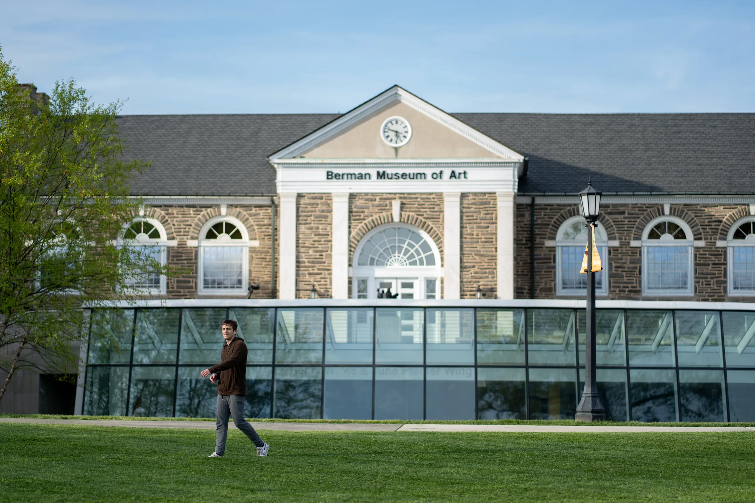 The Berman Museum of Art and its lawn under a spring sky