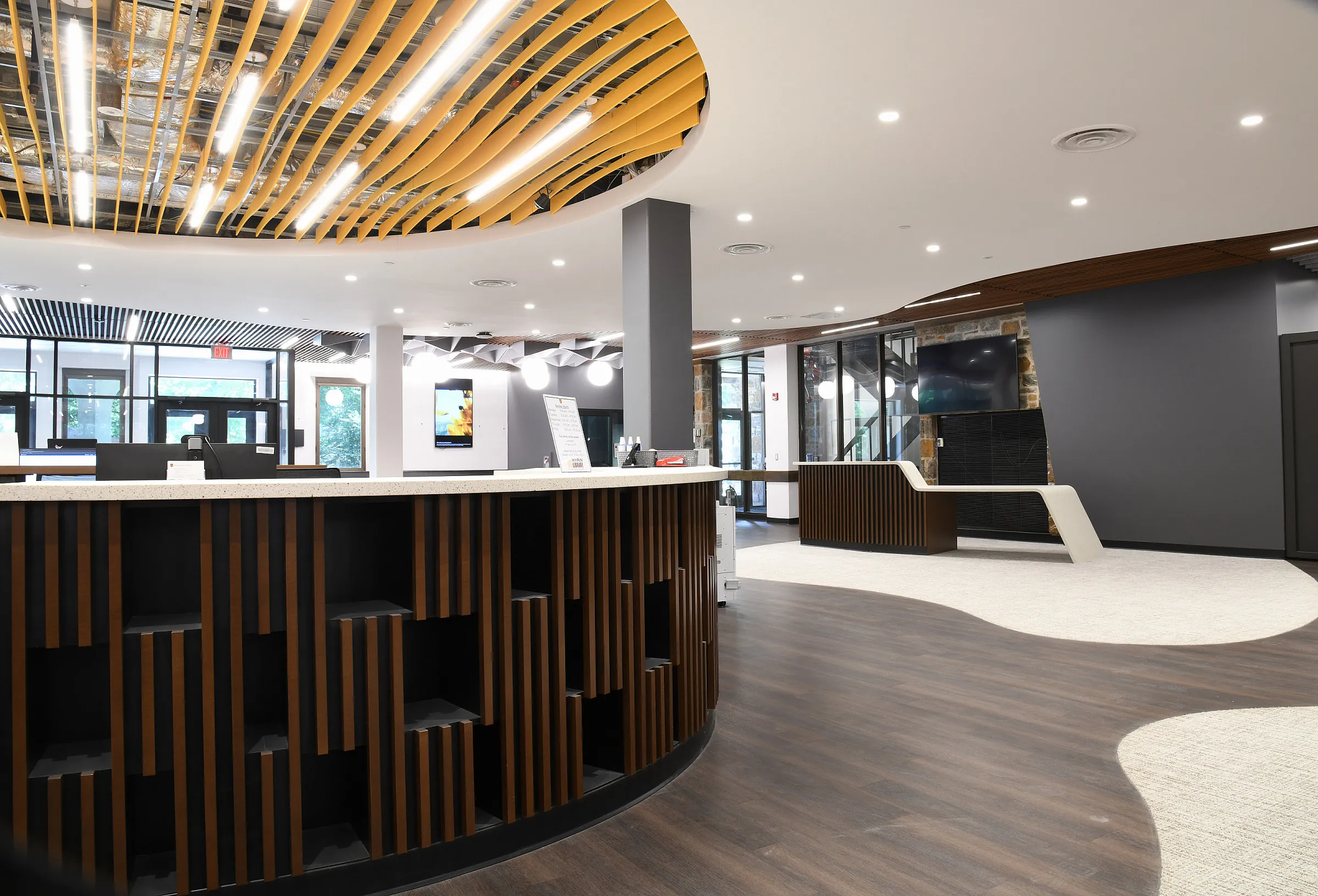 The renovated central service hub of Myrin Library with its curved timber ceiling