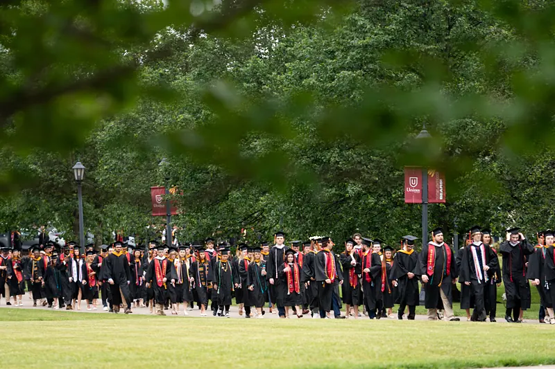 The Commencement procession crossing the lawn in front of the Berman Museum