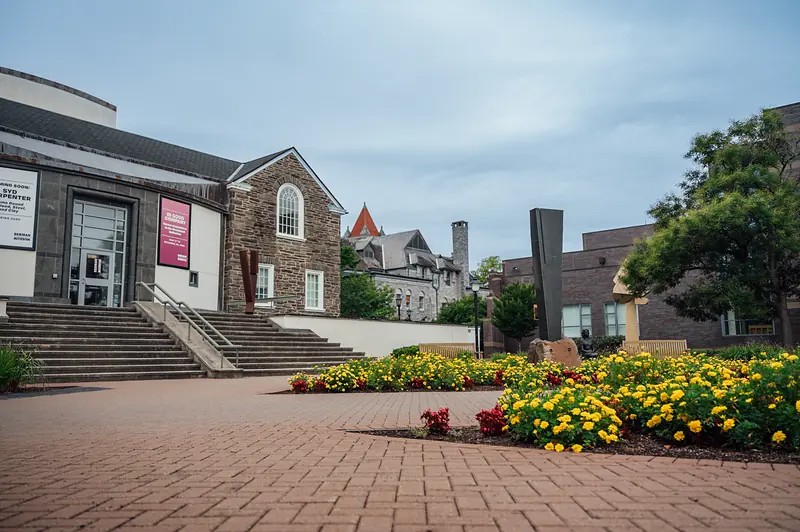 The entrance of the Berman Museum of Art with its summer flower beds