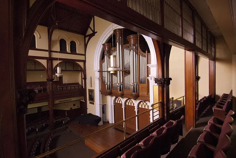 Inside Bomberger Auditorium at Ursinus College — the stage and balcony beneath its gothic arches