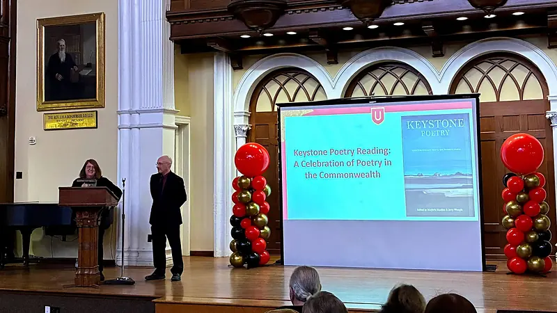 A lecture with projection and podium on the Bomberger Auditorium stage