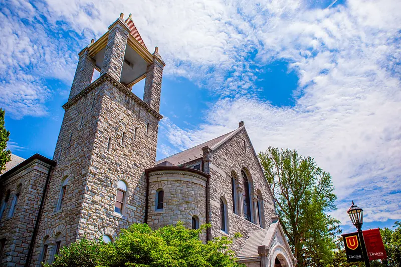 The stone tower of Bomberger Memorial Hall against a summer sky