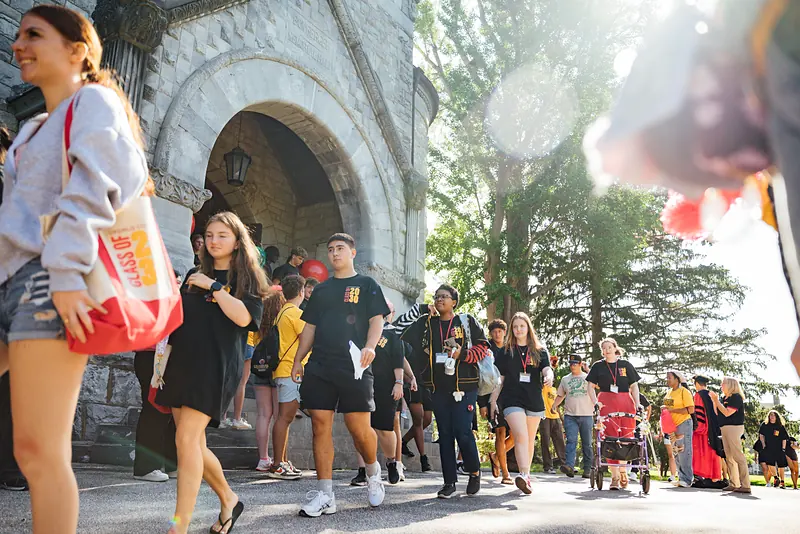 Students processing through the arched entrance of Bomberger Hall at Convocation