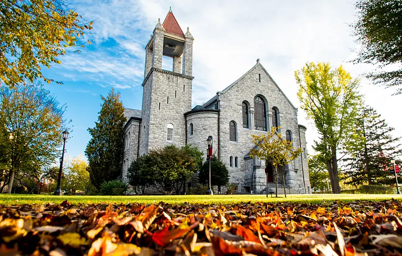 The stone façade of Bomberger Memorial Hall under a blue sky