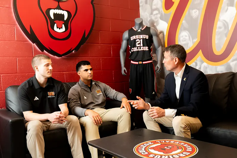 Coaches in conversation in an athletics lounge at Ursinus College