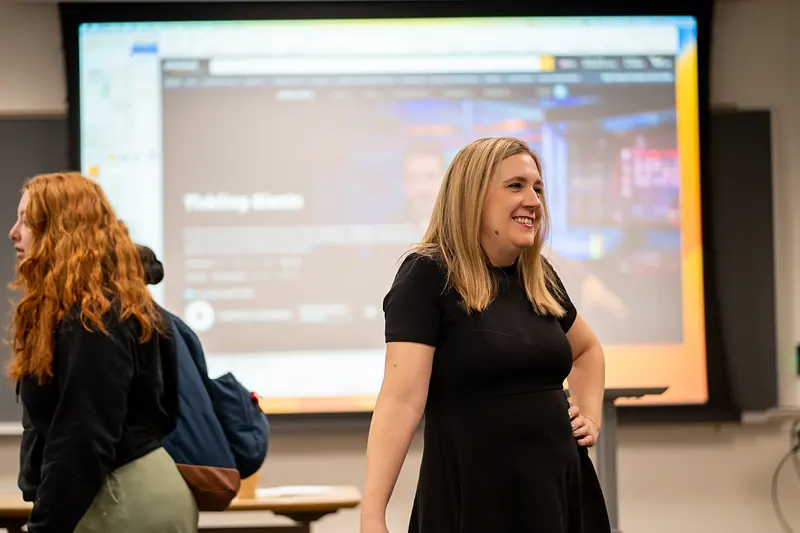 A lecture room at Ursinus College set for a presentation, with a wall-width screen