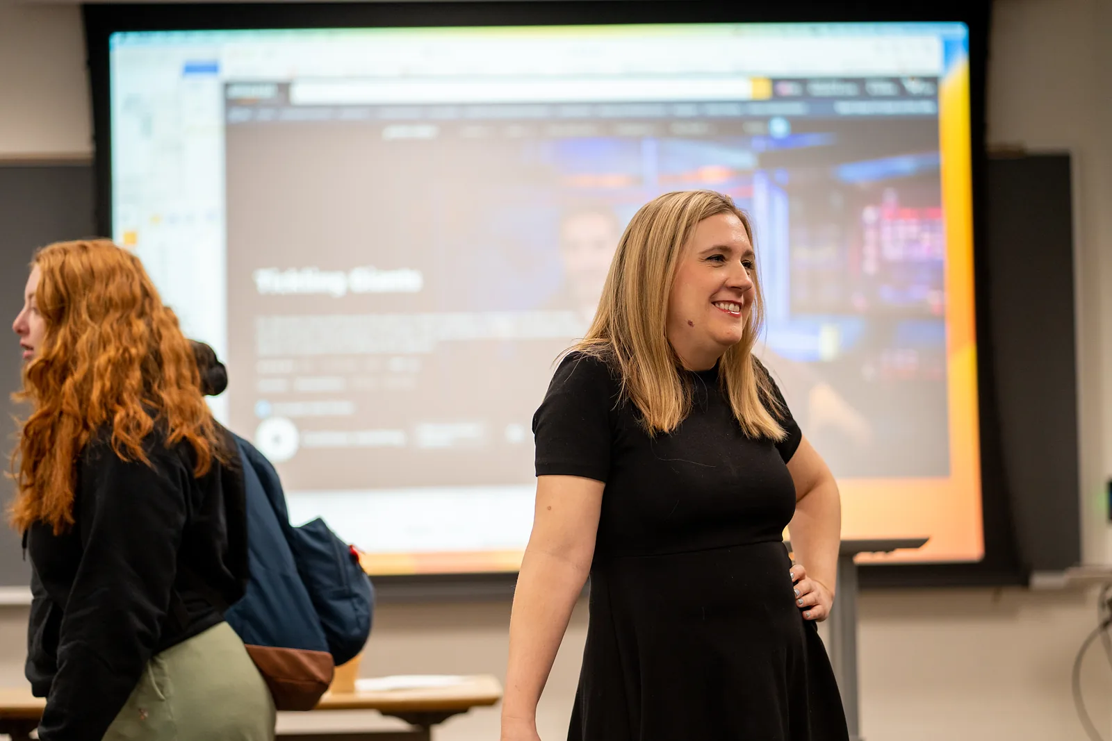 A lecture room at Ursinus College set for a presentation, with a wall-width screen