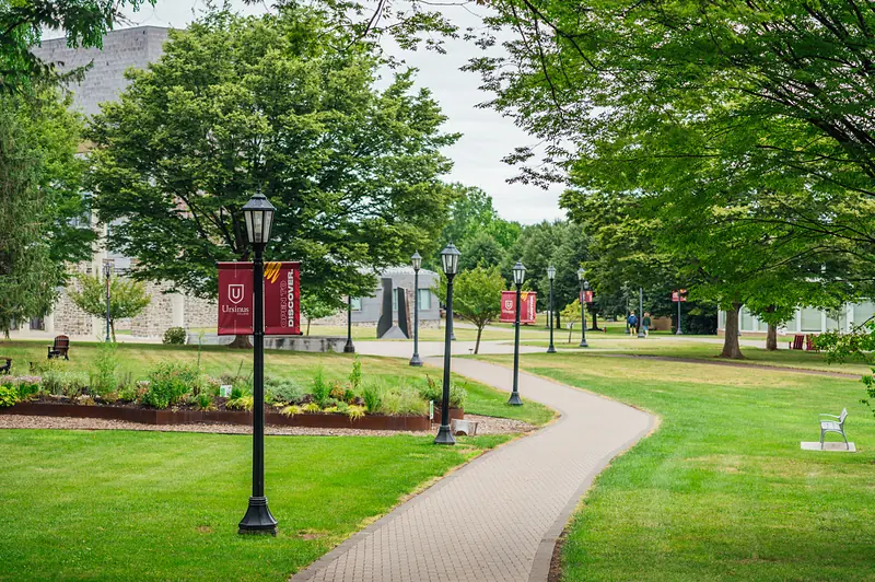 The brick path and Ursinus banners beside Olin Plaza
