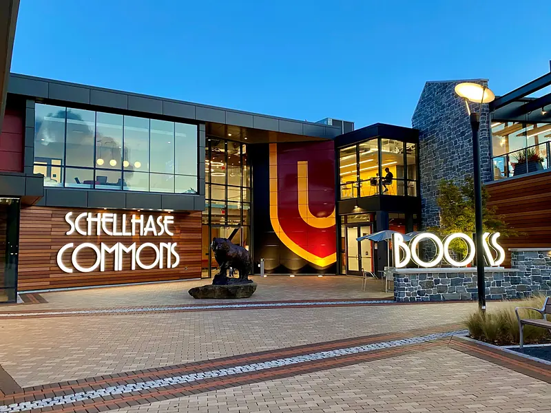 The glass and timber front of Schellhase Commons at the Main Street gateway