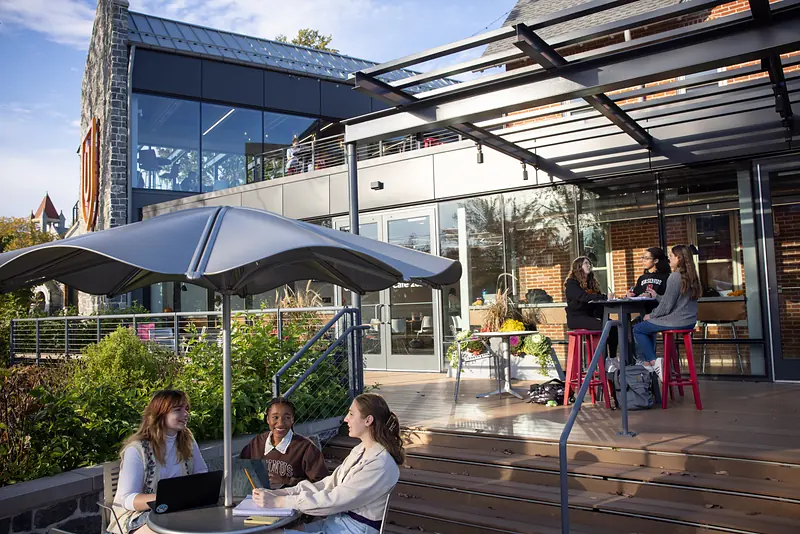 The Schellhase Commons terrace set with tables and umbrellas