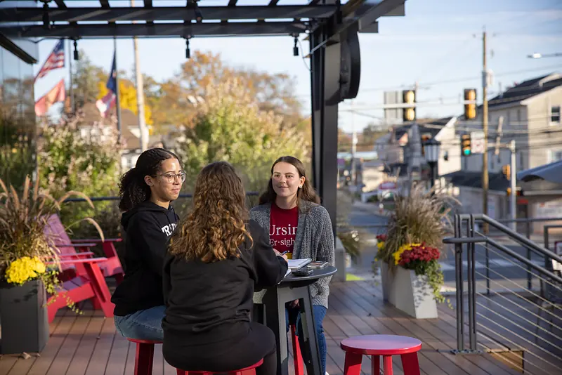 The Commons terrace above Main Street, with flags and lounge seating