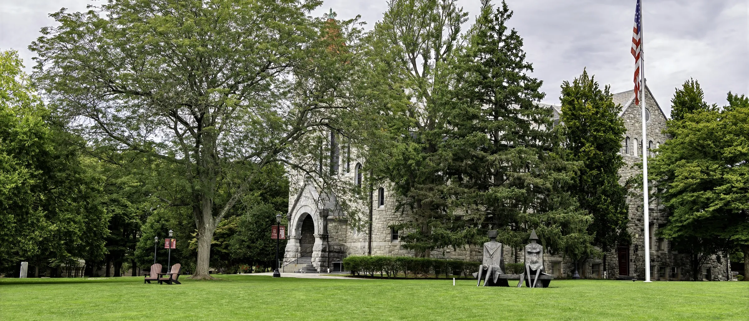 The lawn in front of Bomberger Hall, its stone tower and the trees around it