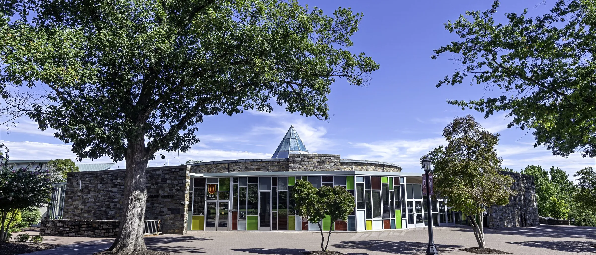 Olin Plaza, the glass front of the Innovation and Discovery Center and the stone halls beyond