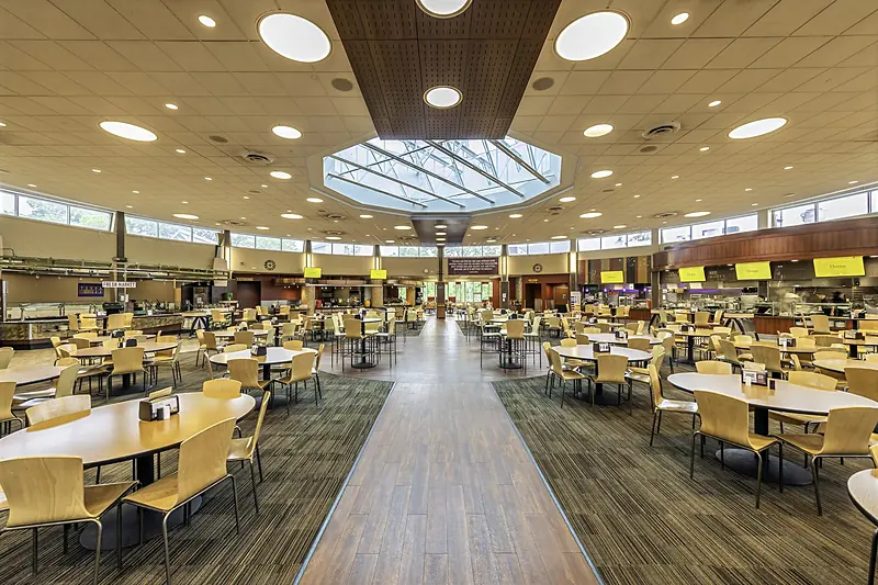Rows of tables under the central skylight of Upper Wismer Dining Hall