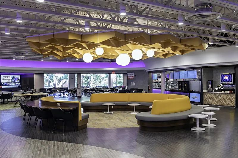 Curved booth seating under globe pendant lights in the Wismer Center Lower Lounge
